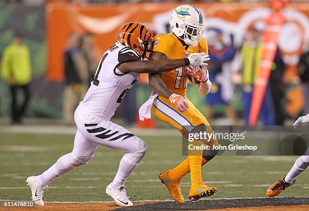 DeVante Parker of the Miami Dolphins is tackled by Darqueze Dennard of the Cincinnati Bengals during the fourth quarter at Paul Brown Stadium on...