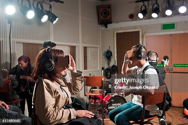 Members of the public view a Virtual Reality video which offers viewers a tour of the famous Abbey Road recording studios using the Google Cardboard...