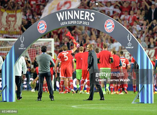 Bayern Munich's manager Pep Guardiola underneath the winners arch