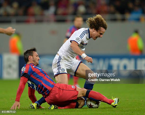 Steaua Bucuresti's Federico Piovaccari and Chelsea's David Luiz battle for the ball