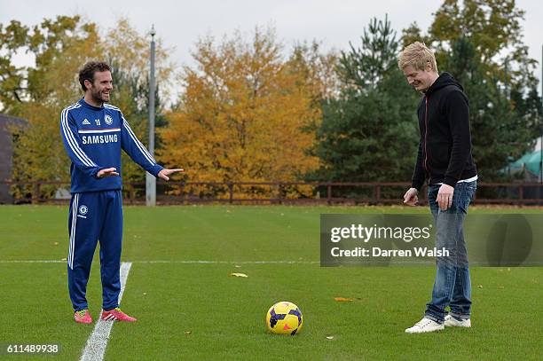 Chelsea's Juan Mata has a kick about with world snooker number one, and big Chelsea supporter, Neil Robertson after a training session at the Cobham...