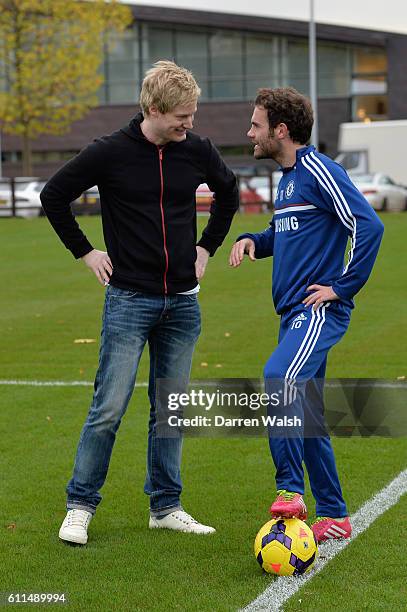 Chelsea's Juan Mata has a kick about with world snooker number one, and big Chelsea supporter, Neil Robertson after a training session at the Cobham...