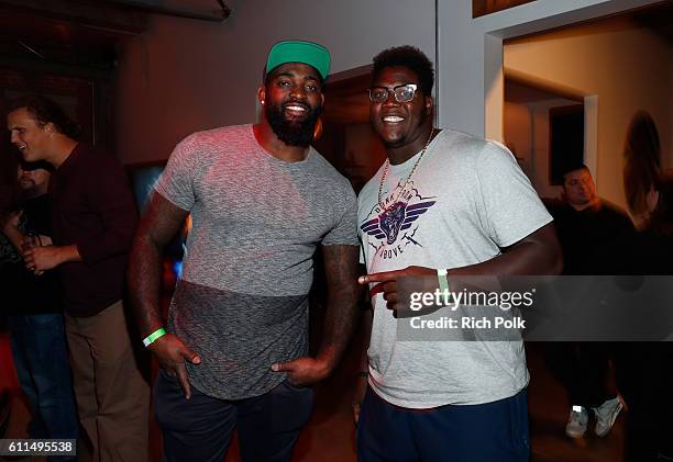 Pro football players Michael Brockers, left, and Jamon Brown attend the Nas, Todd Gurley and LA Rams Host Xbox & Gears of War 4 launch event at The...