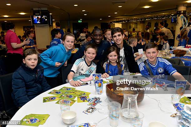 Demba Ba and Oscar during a children's Christmas party at Stamford Bridge