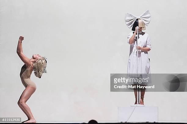 Sia and Maddie Ziegler perform on stage during the opening night of her "Nostalgic for the Present" tour at KeyArena on September 29, 2016 in...