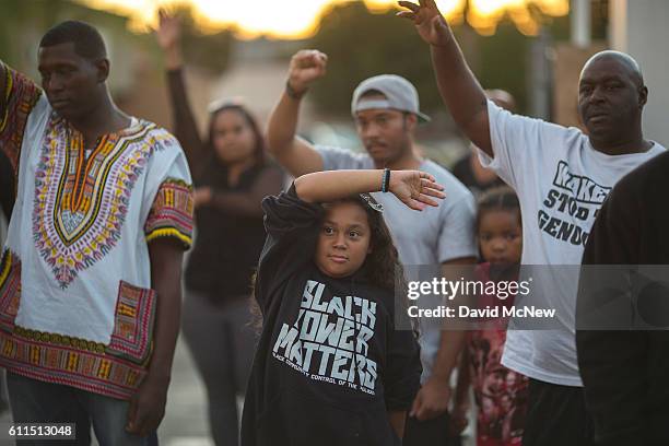 People gather to protest at the site where an unarmed black man, Alfred Olango was shot by police earlier this week on September 29, 2016 in El...