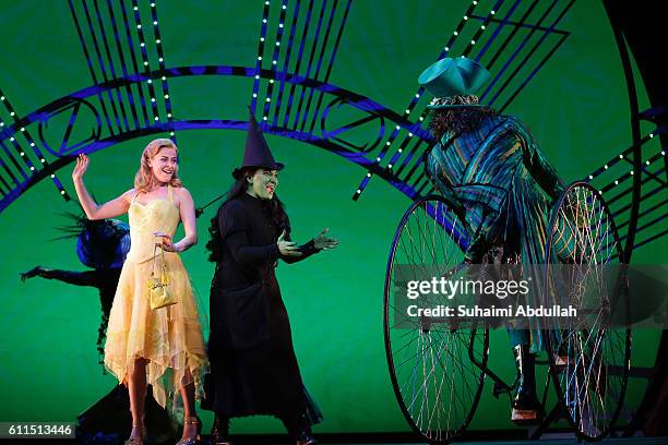 Performers Carly Anderson playing the character 'Glinda' , Jacqueline Hughes playing the character 'Elphaba' and cast members perform on stage during...