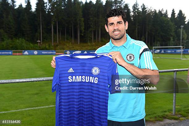 Chelsea's Diego Costa holds up a team shirt