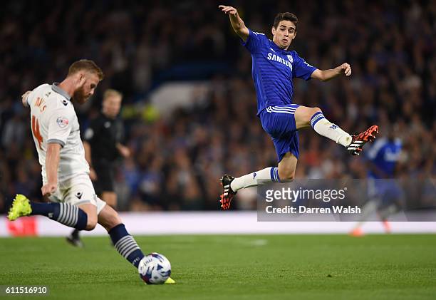 Chelsea's Oscar jumps to block a shot from Bolton Wanderers' Matthew Mills
