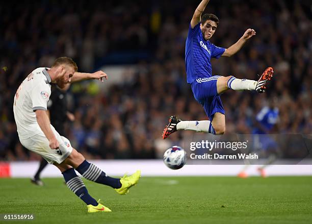 Chelsea's Oscar jumps to block a shot from Bolton Wanderers' Matthew Mills