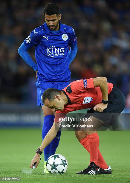 Referee Cüneyt Çakr uses his vanishing spray as Riyad Mahrez of Leicester City watches during the UEFA Champions League match between Leicester City...