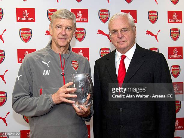 Arsenal manager, Arsene Wenger is presented a gift by Chairman Sir Chips Keswick to mark his twenty years at the club at a press conference at London...