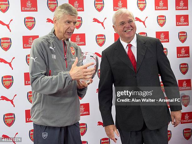 Arsenal manager, Arsene Wenger is presented a gift by Chairman Sir Chips Keswick to mark his twenty years at the club at a press conference at London...