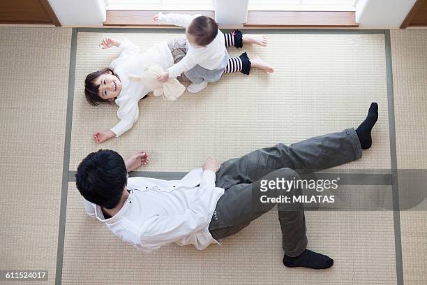 japanese families lie down in the japanese-style room - child lying down stock pictures, royalty-free photos & images