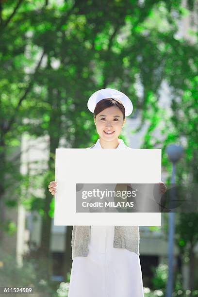 japanese nurse with a white board - nurse hat stock pictures, royalty-free photos & images