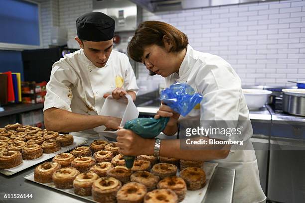 Bakers are seen decorating Cronuts with ice piping ahead of the opening of the Dominique Ansel Bakery in London, U.K., on Friday, Sept. 30, 2016. The...