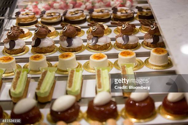 Selection of cakes and tarts sit on a counter during the opening of the Dominique Ansel Bakery in London, U.K., on Friday, Sept. 30, 2016. The...