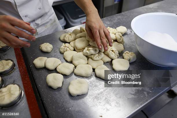 Bakers prepare the dough for pastries during the opening of the Dominique Ansel Bakery in London, U.K., on Friday, Sept. 30, 2016. The Cronutthe...