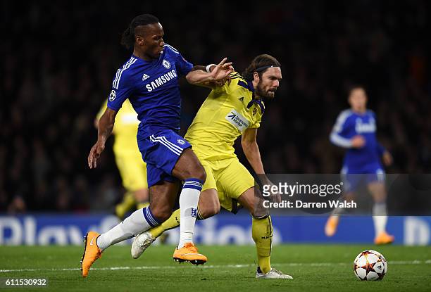 Chelsea's Didier Drogba and NK Maribor's Marko Suler battle for the ball