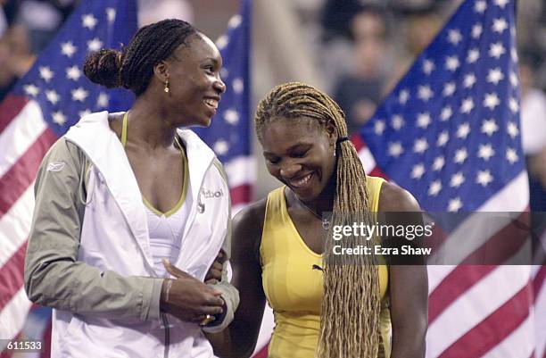 Venus and Serena Williams talk during the trophy presentation after the final the women's final match of the US Open at the USTA National Tennis...