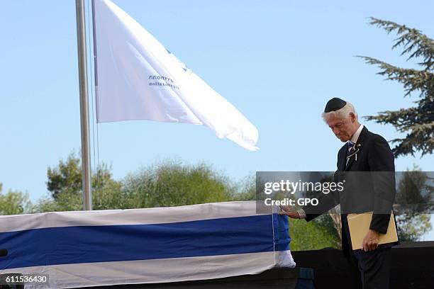 In this handout photo provided by the Israel Government Press Office , Former U.S President Bill Clinton touches the coffin of Shimon Peres during...