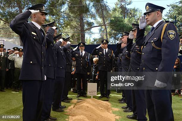 In this handout photo provided by the Israel Government Press Office , Members of a Knesset guard salute during the funeral of the former Israeli...