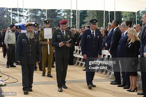 In this handout photo provided by the Israel Government Press Office , Members of a Knesset guard carry the flag-draped coffin during the funeral of...