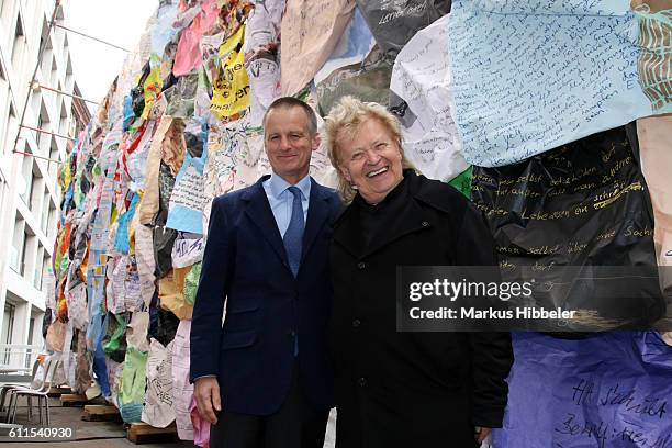 Artist HA Schult and Uwe Schmitz, CEO of Frankonia Eurobau pose for media during the unveiling of the new art project 'Freiheitswand' at Grosse...