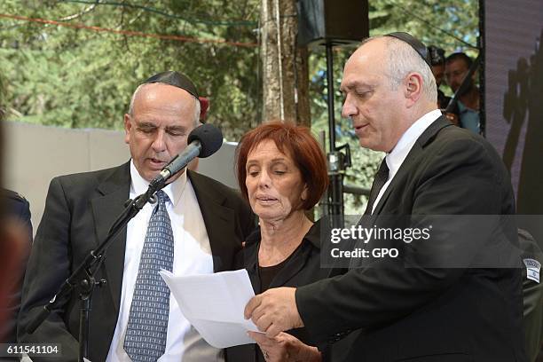 In this handout photo provided by the Israel Government Press Office , Yoni Peres, Tsvia Walden and Chemi Peres attend the funeral ceremony held for...