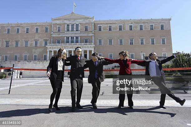 Protesters with masks dancing in front of the Greek Parliament during demonstrations in Athens, Greece, Oct 19, 2011. On the first day of a 48hr...