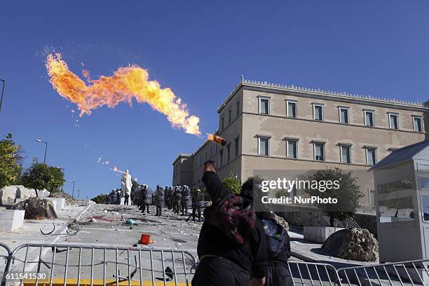 Protester throws a molotov bomb during demonstrations in Athens, Greece, Oct 19, 2011. On the first day of a 48hr general strike over 100.000 people...