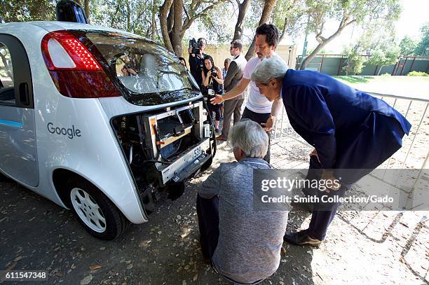 Photograph of Google co-founder Sergey Brin showing US Secretary of State John Kerry the computer inside a self-driving car, Palo Alto, California,...