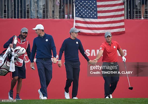 Team Europe Justin Rose Team USA Jordan Spieth and Patrick Reed walk during the Morning Foursome matches at the 41st Ryder Cup at Hazeltine National...