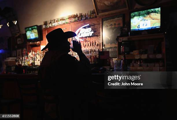Don "Scottie" Scott, 71 and retired, drinks and watches television at the Doc Hollidays Saloon on September 29, 2016 in Benson, Arizona. Tombstone...