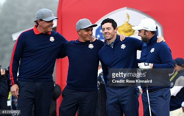 Phil Mickelson and Rickie Fowler of the United States pose on the first tee with Rory McIlroy and Andy Sullivan of Europe during morning foursome...