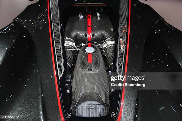 The Aperta's engine derived from Ferraris Formula 1 race cars, sits under a glass panel on the LaFerrari Aperta automobile, produced by Ferrari NV,...