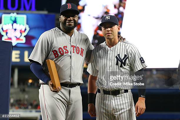 Jacoby Ellsbury of the New York Yankees presents a a gift to David Ortiz of the Boston Red Sox during a pregame ceremony at Yankee Stadium on...
