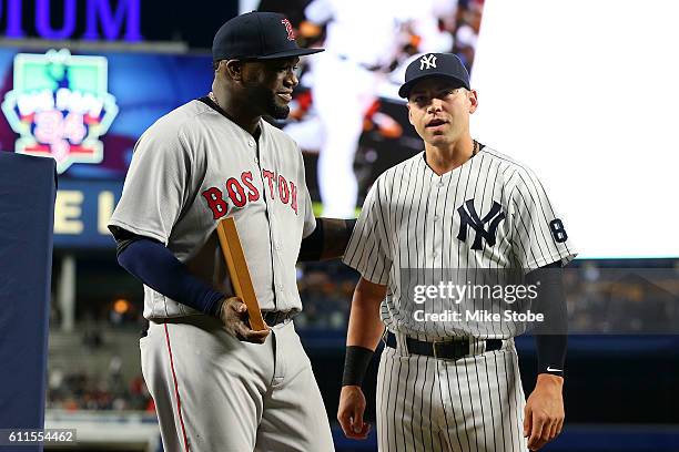 Jacoby Ellsbury of the New York Yankees presents a a gift to David Ortiz of the Boston Red Sox during a pregame ceremony at Yankee Stadium on...