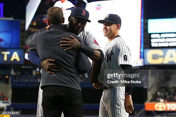 Jacoby Ellsbury of the New York Yankees and David Cone presents a gift to David Ortiz of the Boston Red Sox during a pregame ceremony at Yankee...