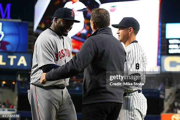 Jacoby Ellsbury of the New York Yankees and David Cone presents a gift to David Ortiz of the Boston Red Sox during a pregame ceremony at Yankee...