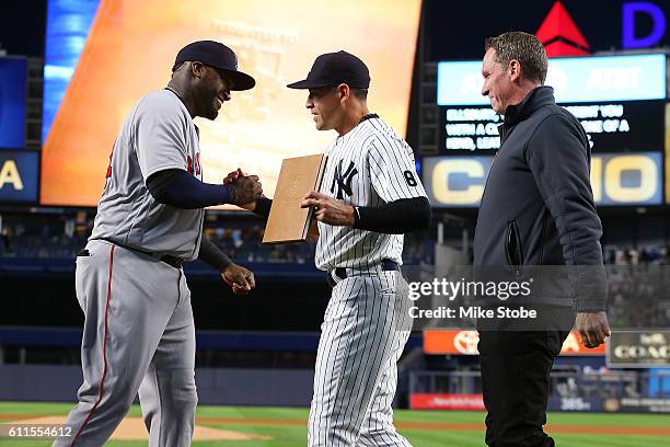 Jacoby Ellsbury of the New York Yankees and David Cone presents a gift to David Ortiz of the Boston Red Sox during a pregame ceremony at Yankee...