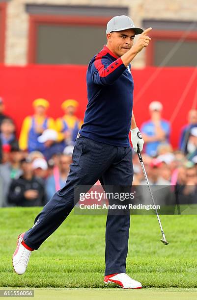 Rickie Fowler of the United States reacts after chipping in on the ninth hole during morning foursome matches of the 2016 Ryder Cup at Hazeltine...