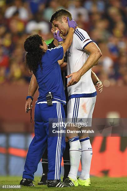 Chelsea's Gary Cahill injured after scoring the equaliser and is treated by Dr Eva Carneiro and Jon Fearn during a Pre Season Friendly match between...