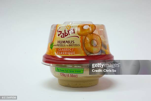 Toronto, ON - SEPTEMBER 29 Campbell's hearty noodles, chicken flavor, Sabra Hummus and pretzels, snack fare that is served in economy section of Air...