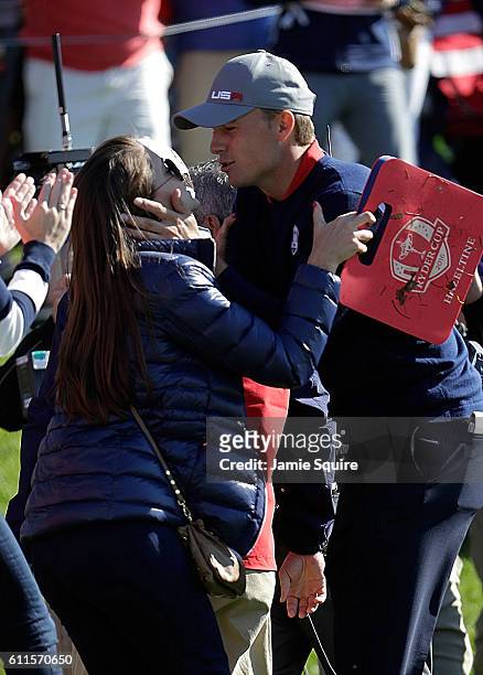 Jordan Spieth of the United States kisses Annie Verret during morning foursome matches of the 2016 Ryder Cup at Hazeltine National Golf Club on...