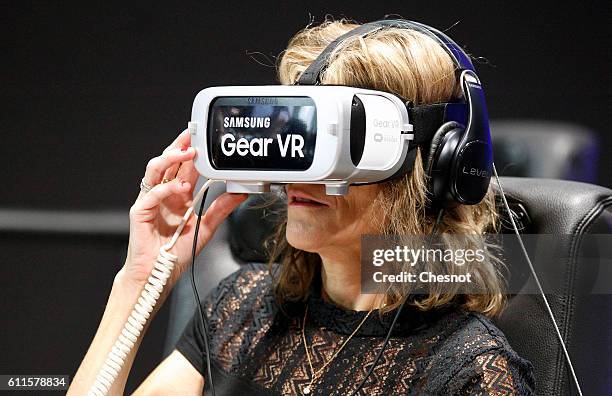 Visitor plays a game with the virtual reality head-mounted Samsung Gear VR powered by Oculus during the second press day of the Paris Motor Show on...