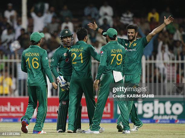 Pakistan's players celebrate after bowling out West Indies' batsman during the 1st ODI match between Pakistan and West Indies at the Sharjah Cricket...