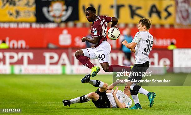 Erich Berko of Dresden challenges Philipp Klingmann of Sandhausen and Thomas Pledl of Sandhausen during the Second Bundesliga match between SV...