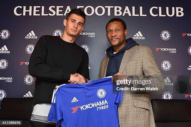 Chelsea's new signing Matt Miazga signs for Chelsea FC and holds the home shirt with technical director Michael Emenalo at the Cobham Training Ground...