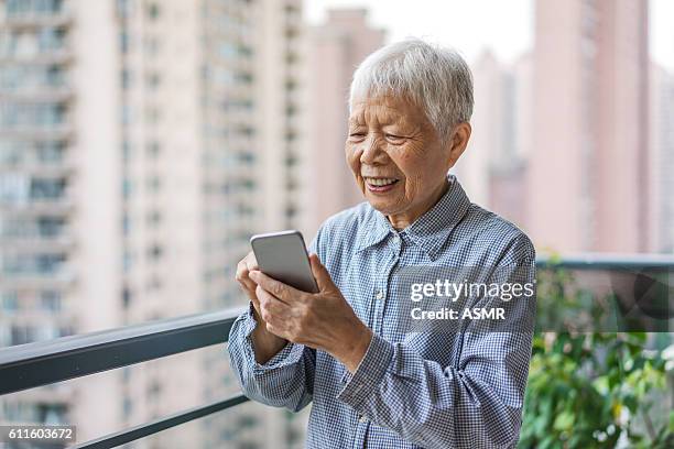 senior woman using mobile phone - retiremen stock pictures, royalty-free photos & images